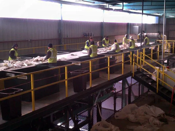 Technician servicing recycling equipment to maintain performance